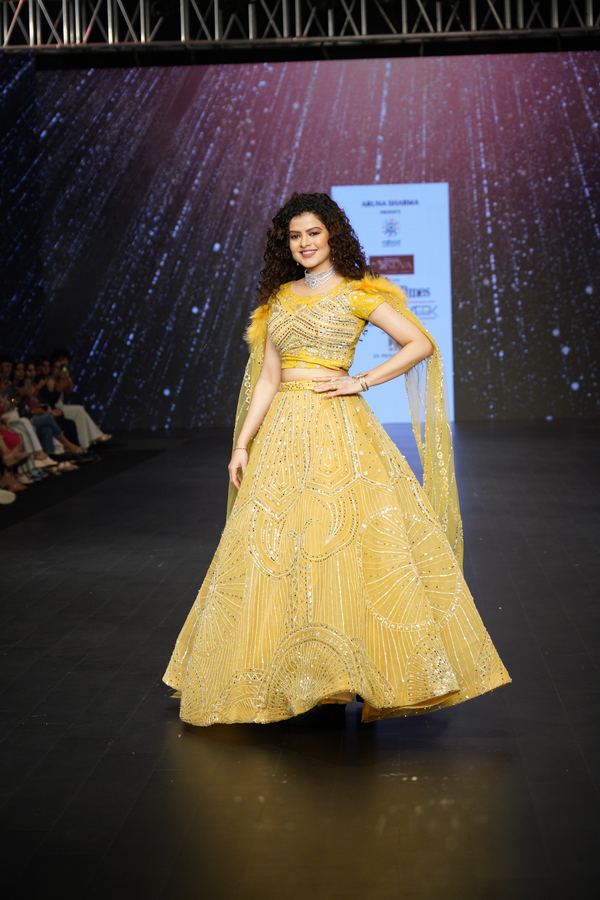 Two participants walking the runway in coordinated gowns