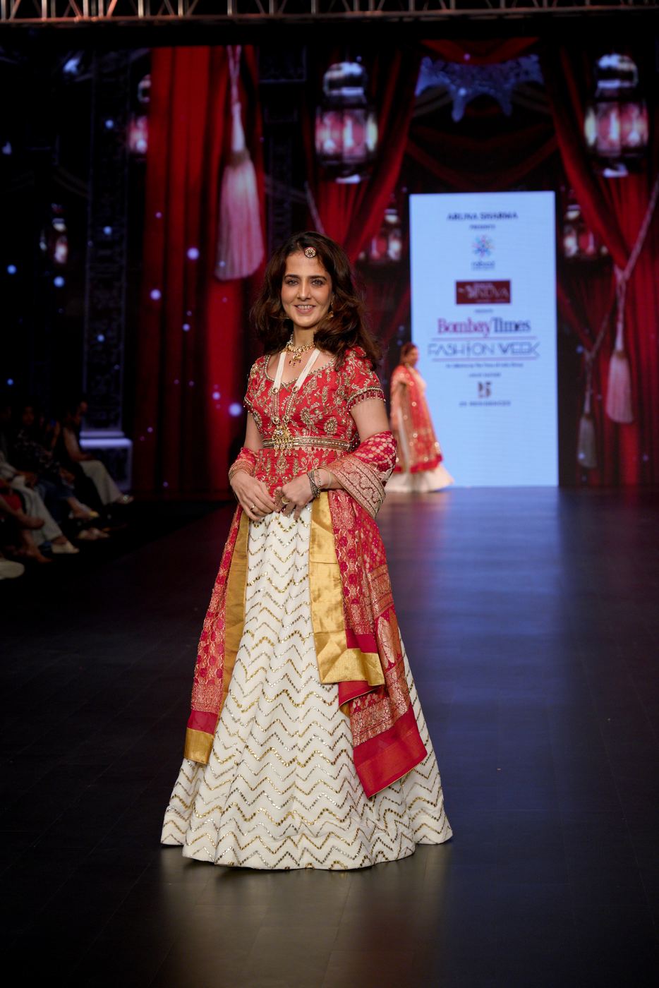 Model walking the runway in a flowing purple gown at a Catwalk For A Cause event